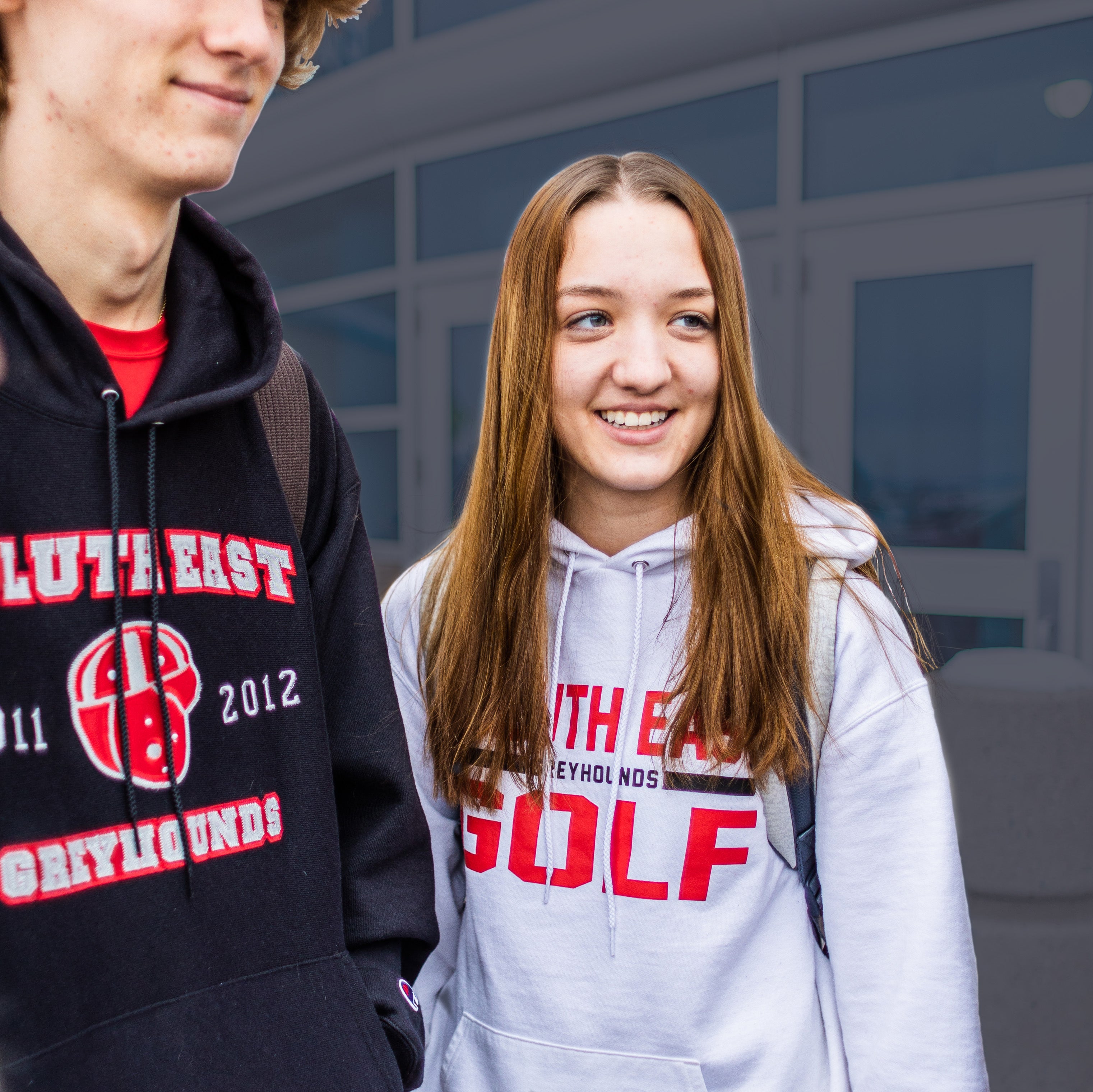 Two Duluth East students wearing screen printed sweatshirts from On The Limit.